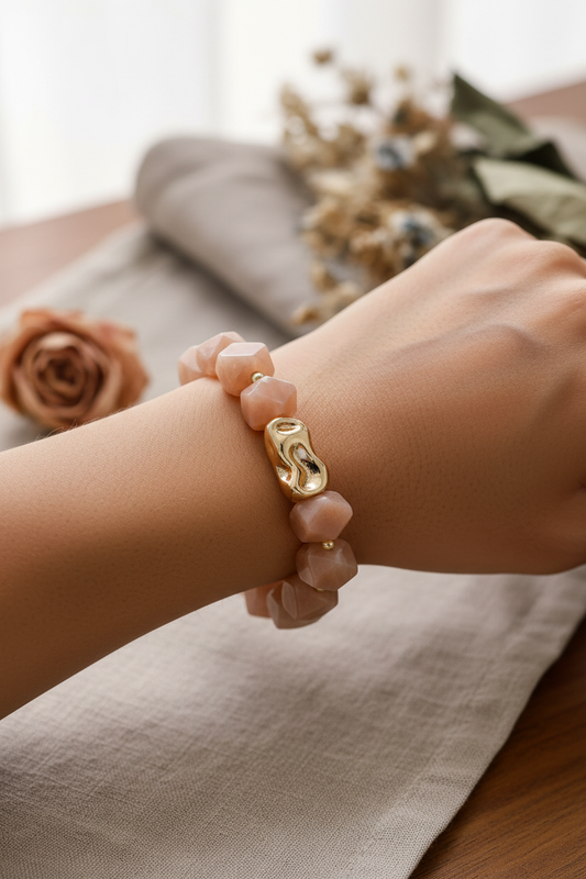 Model wearing peach moonstone bracelet